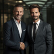 © ivlianna - Business portrait of two happy smiling men in suits, work team, shaking hands