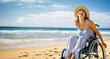Handicapped or disabled woman in a wheelchair, enjoying the sun on a beach. Shallow field of view with copy space.