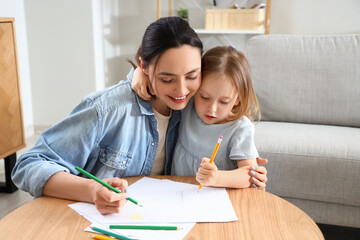 Canvas Print - Young woman with her little daughter drawing at home