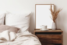 Portrait White Frame Mockup On Retro Wooden Bedside Table. Modern White Ceramic Vase, Dry Lagurus Ovatus Grass. Cup Of Coffee And Books In Bed. Beige Linen Pillows In Bedroom. Generative AI