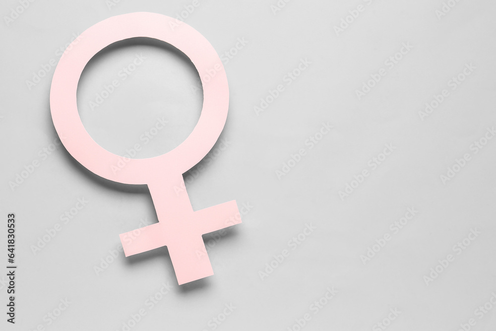 Paper symbol of female on grey background