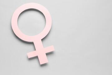 Wall Mural - Paper symbol of female on grey background