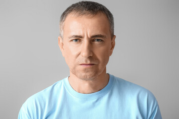 Poster - Portrait of serious mature man on grey background