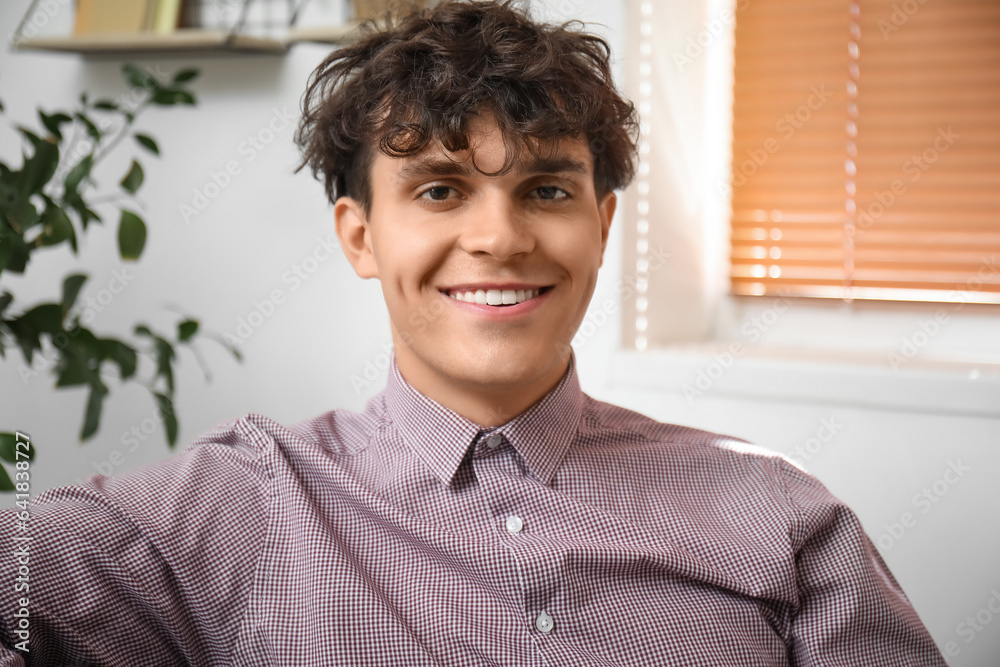 Portrait of handsome young man in room