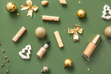 Composition With Makeup Products And Golden Christmas Decor On Dark Green Background