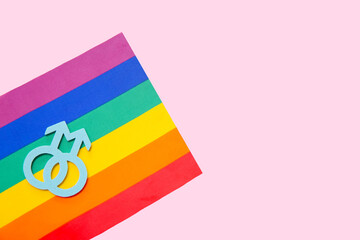 Rainbow flag and gay symbol on pink background. LGBT concept