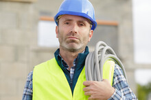 Construction Worker Holding Cables Outdoors