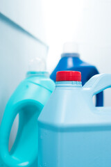 Wall Mural - Some blue liquid soap bottles on blue background