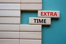 Extra Time Symbol. Concept Word Extra Time On Wooden Blocks. Beautiful Grey Green Background. Business And Extra Time Concept. Copy Space