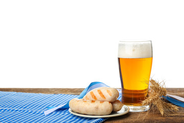 Glass of cold beer and plate with sausages on table against white background. Oktoberfest celebration