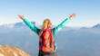 © 24K-Production - Happy young hiker woman with raised arms in the mountains in autumn