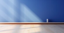 Sapphire Blue Wall Contrasting With A Light Pine Floor, With The Delicate Dance Of Sunlight
