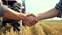 Handshake Of Men Farmers In Shirts Against The Background Of A Wheat Field With A Tractor,