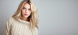 © SnowElf - Young Girl blonde in knitted warm sweater portrait isolated on flat background with copy space. Knitted natural clothing store banner template. Autumn fashion collection.