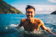 © VisualProduction - Portrait of handsome young asian man smiling and having fun while swimming in the ocean