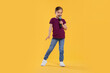 © New Africa - Cute little girl with microphone singing on yellow background