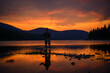 Man fly fishing in a Montana lake at sunset.
