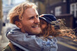 © Marko Geber - Young caucasian couple hugging and embracing each other on a sidewalk in the city