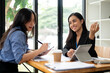 © bongkarn - Two businesswomen or accountants are discussing work and planning a financial project