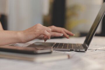 Cropped photo of Freelancer business Asian woman holding coffee cup and at doing planning analyzing the financial report, business plan investment, finance analysis the workplace.