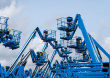 Group Of Aerial Work Platforms For Construction And Material Handling. Close-up To The Basket For Moving People