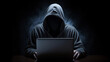 © Linus - Person with Hidden Face and Laptop Engaged in Dark Cyber Work in a Black Background