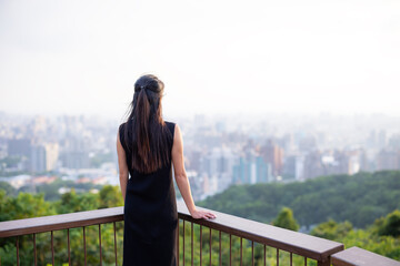 Wall Mural - Woman look at the city view on the top