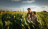 Fototapeta  - A farmer and his two sons examine the future corn harvest. a tractor in the background. Generative ai
