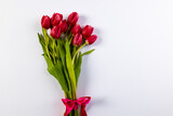 Fototapeta Tulipany - Bunch of red tulips with copy space on white background