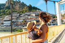 A Woman With Her Son On The Bridge In The Historic City Of Berat In Albania, UNESCO