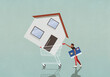 © fStop - Man with credit card pushing house in shopping cart