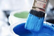 © fStop - Close up of blue paint pot and dripping paintbrush