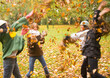 © fStop - Young girls playing with leaves in the park
