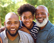 © Monkey Business - Portrait Of Multi-Generation Male Family Having Fun Playing Outdoors In Garden Park Or Countryside
