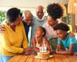 © Monkey Business - Multi-Generation Family Celebrating Granddaughter's Birthday With Cake And Candles At Home