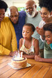 © Monkey Business - Multi-Generation Family Celebrating Granddaughter's Birthday With Cake And Candles At Home