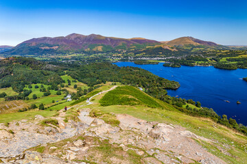 Wall Mural - Hikers ascending a ridge overlooking a large lake (Catbells and Keswick, Cumbria)