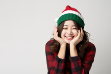 Young Cute, Beautiful Long Hairstyle Asian Woman Smiling With Happiness And Joy, Wearing Red Sweater, Green, Red Christmas Beanie In White Background. Christmas Holidays Celebration, New Year Concept