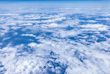 Fototapeta Na sufit - High-altitude cloud scenery outside the airplane window