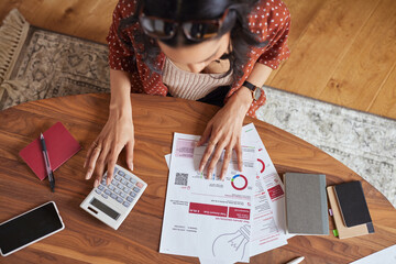 Woman calculating financial bill at home