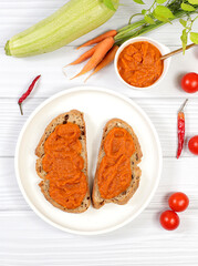 Wall Mural - Sandwich with cereal bread and pumpkin caviar on wooden background, healthy breakfast with ingredients, healthy eating concept, space for text, selective focus