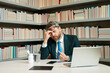 © Volodymyr - Business man suffering from headache after computer work, exhausted with closed eyes touching head, relieving pain, migraine. Business problems. Bankruptcy, financial problem and crisis concept.