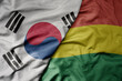 big waving national colorful flag of south korea and national flag of bolivia .