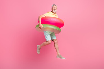 Sticker - Full body photo of tourist active lifestyle swim abroad warm ocean water retired man wear double lifebuoys isolated on pink color background