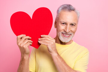 Sticker - Portrait of positive person with white beard wear stylish t-shirt hands demonstrate large heart postcard isolated on pink color background