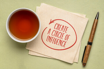 Create a circle of influence advice  - inspirational handwriting on a napkin with a cup of tea