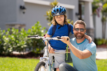 Fathers day. Happy family, men generations. Concept of friendly family and summer lifestyle. Father and son riding a bike in american neighborhood. Parents and children friends. Child first bike.