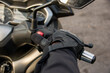 Close-up of a motorcyclist's hand pressing the stop button of his motorcycle.
