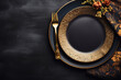 Golden cutlery on black background. Black empty ceramic plate with golden fork. Fashionable and luxury eating. Flat-lay, top view. Copy space for your text.