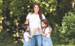 © Louis-Paul Photo - Pregnant woman posing in the parkwith her two childs